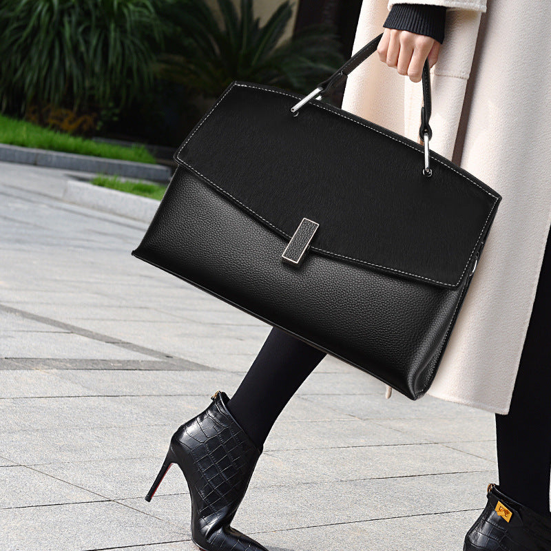 Spacious Black Leather Commuter Bag with Textured Flap and Rectangular Clasp